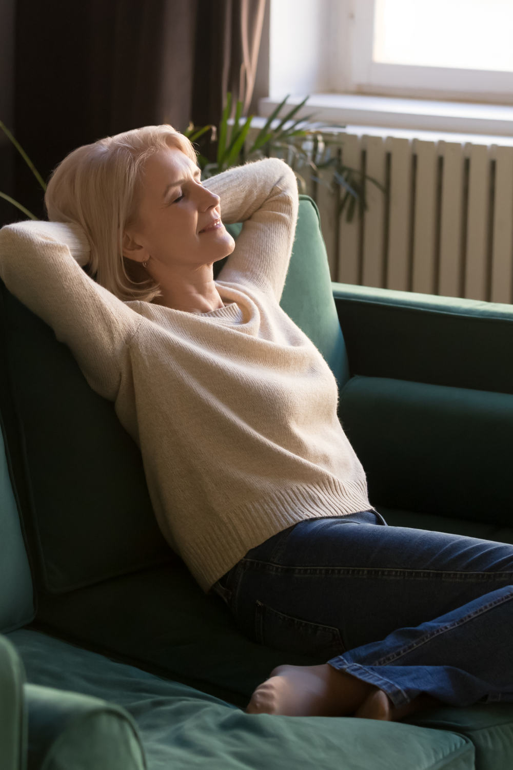Woman resting on couch with eyes closed